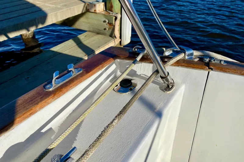 Slide: The Image of Close-up of 1979 Outer Reef 26/31 sailboat deck with ropes and dock in background. - 25