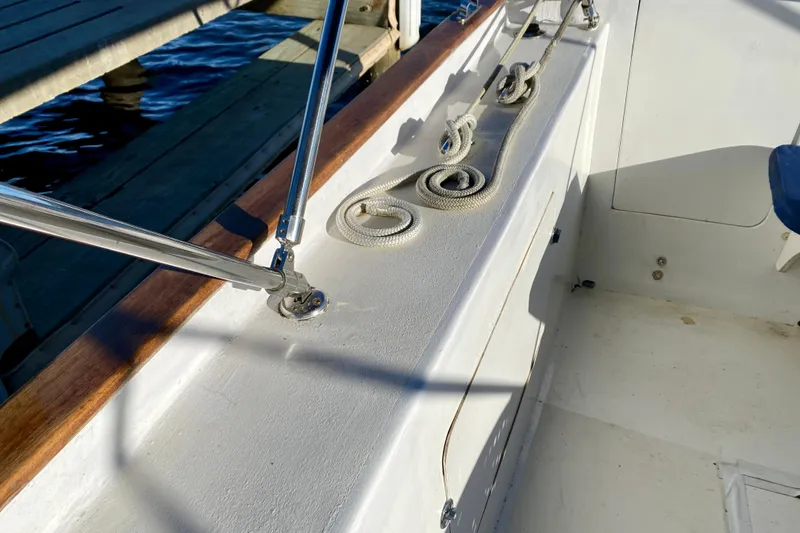 Slide: The Image of 1979 Outer Reef 26/31 boat deck with coiled rope and railing. - 26