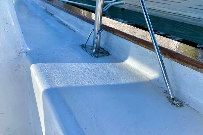 Slide: The Image of Close-up of 1979 Outer Reef 26/31 boat deck with metal railing and wooden trim. - 27