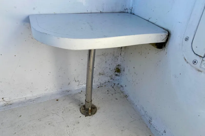 Slide: The Image of Small white corner table on a 1979 Outer Reef 26/31 boat. - 29
