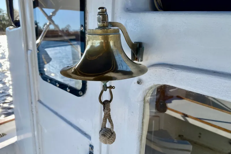 Slide: The Image of Brass bell on 1979 Outer Reef 26/31 boat, reflecting sunlight on white surface. - 30