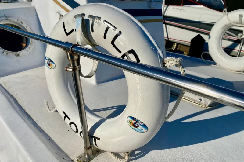 Slide: The Image of Life preserver on 1979 Outer Reef 26/31 boat deck, labeled "Little Toot." - 31