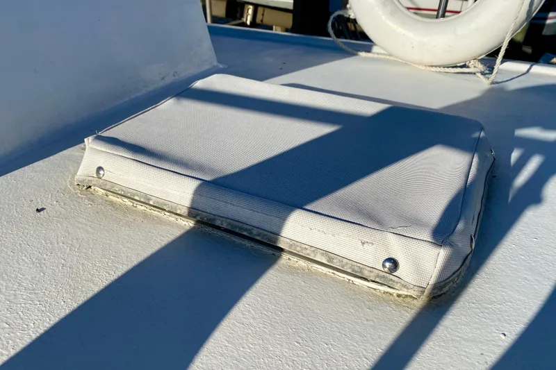 Slide: The Image of Cushioned hatch cover on 1979 Outer Reef 26/31 boat deck with shadows. - 32