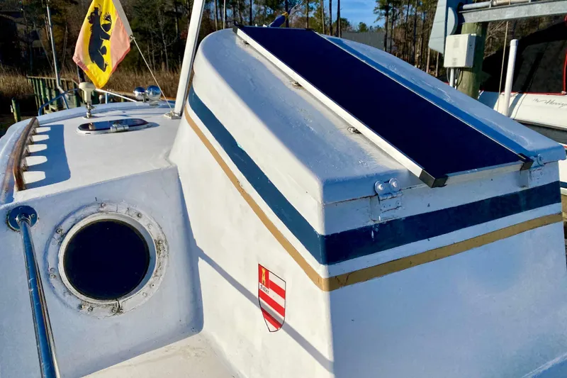 Slide: The Image of 1979 Outer Reef 26/31 boat with solar panel and flag on deck. - 33