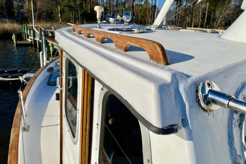 Slide: The Image of 1979 Outer Reef 26/31 boat deck with wooden railings and metal fittings. - 35
