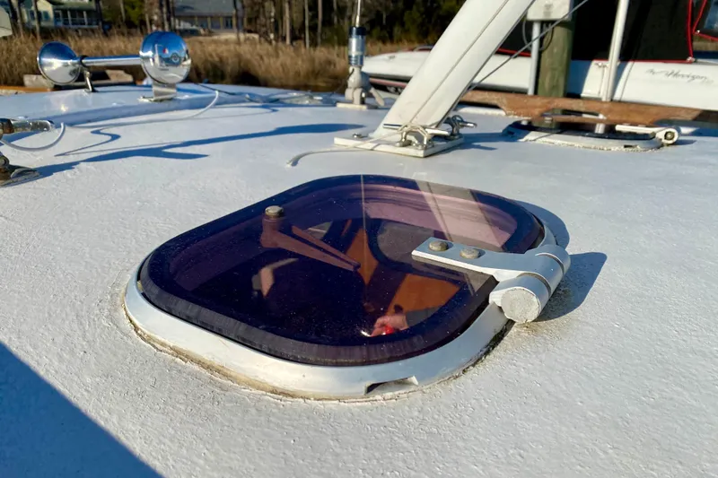 Slide: The Image of Close-up of a 1979 Outer Reef 26/31 boat hatch with blue-tinted glass. - 38