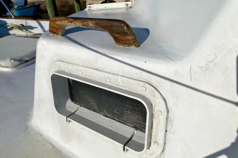 Slide: The Image of Close-up of a 1979 Outer Reef 26/31 boat vent with wooden handle. - 41