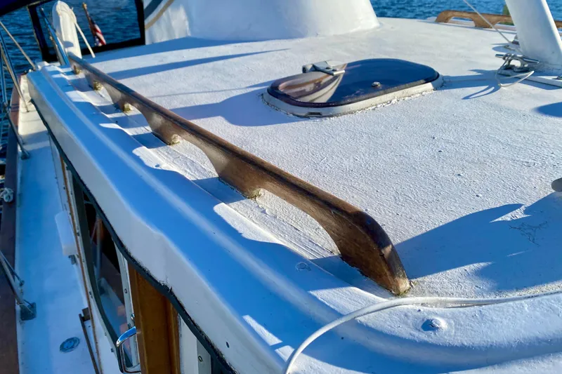 Slide: The Image of 1979 Outer Reef 26/31 boat deck with wooden rail and hatch, sunlit. - 51