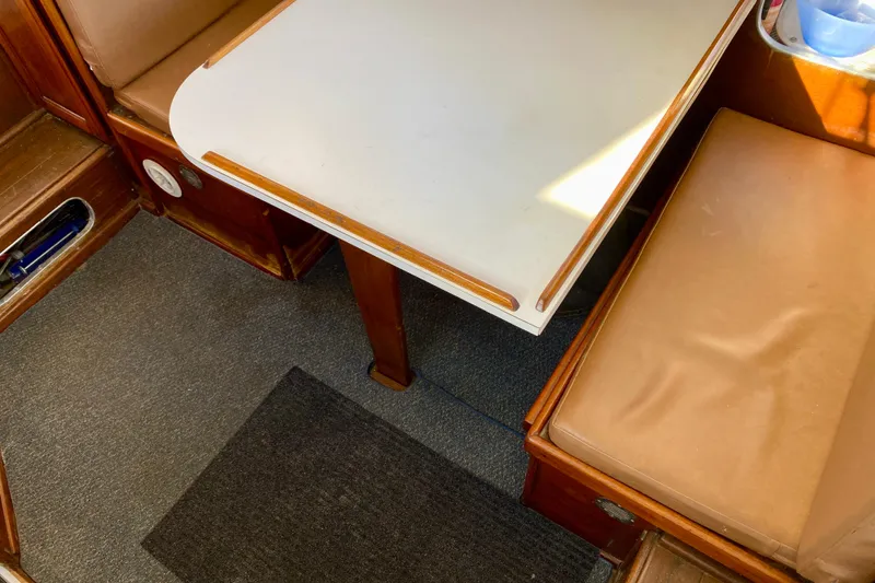 Slide: The Image of Interior of 1979 Outer Reef 26/31 boat with table and cushioned seating. - 57