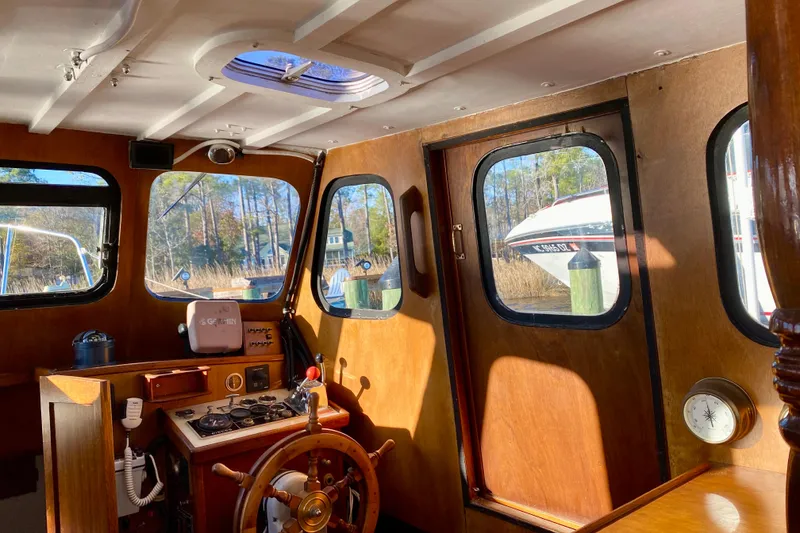 Slide: The Image of Interior of a 1979 Outer Reef 26/31 boat with wooden helm and navigation equipment. - 72