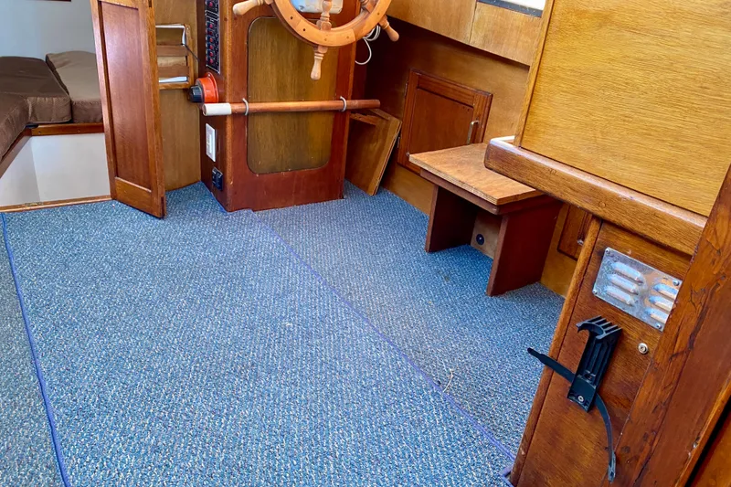Slide: The Image of Interior of 1979 Outer Reef 26/31 boat with wooden helm and blue carpet. - 73