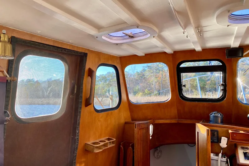 Slide: The Image of Interior of 1979 Outer Reef 26/31 boat with wooden paneling and large windows. - 74
