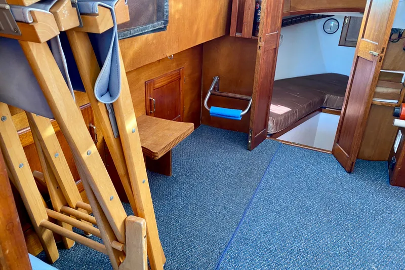 Slide: The Image of Interior of 1979 Outer Reef 26/31 boat with wooden furnishings and blue carpet. - 75