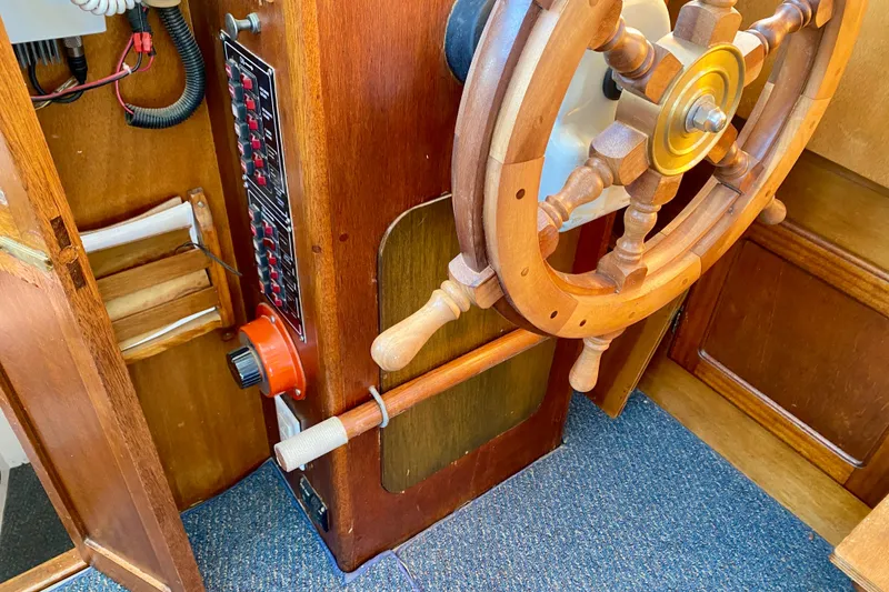 Slide: The Image of Wooden steering wheel and control panel of a 1979 Outer Reef 26/31 boat. - 76
