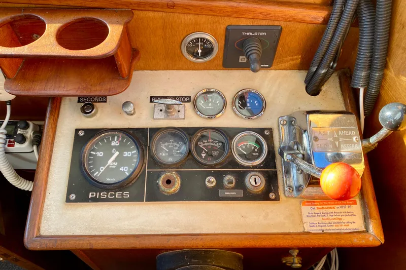 Slide: The Image of Control panel of a 1979 Outer Reef 26/31 boat with gauges and throttle. - 78