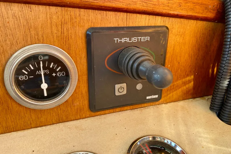 Slide: The Image of Control panel of a 1979 Outer Reef 26/31 boat with thruster joystick and amp gauge. - 79