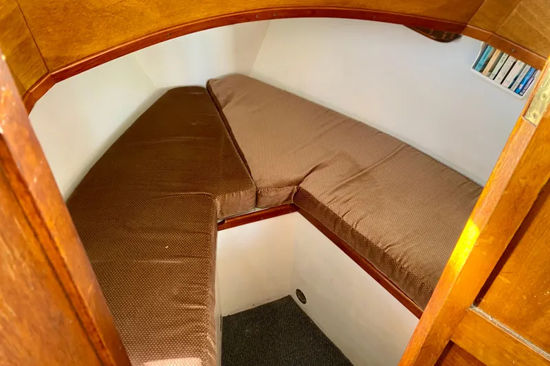 Slide: The Image of 1979 Outer Reef 26/31 boat cabin with brown cushions and wooden interior. - 81