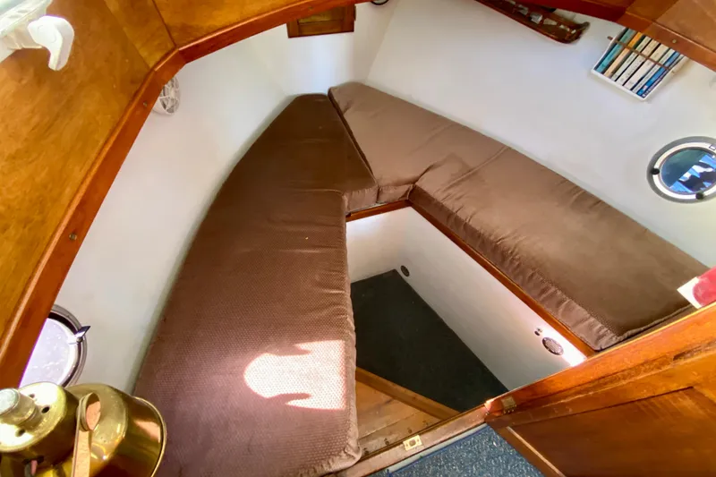 Slide: The Image of Cozy cabin interior of 1979 Outer Reef 26/31 boat with brown cushions and wooden accents. - 82