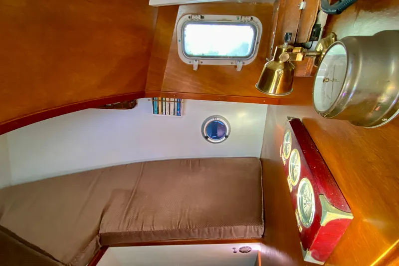Slide: The Image of Cozy cabin interior of 1979 Outer Reef 26/31 boat with wooden finish and nautical instruments. - 83