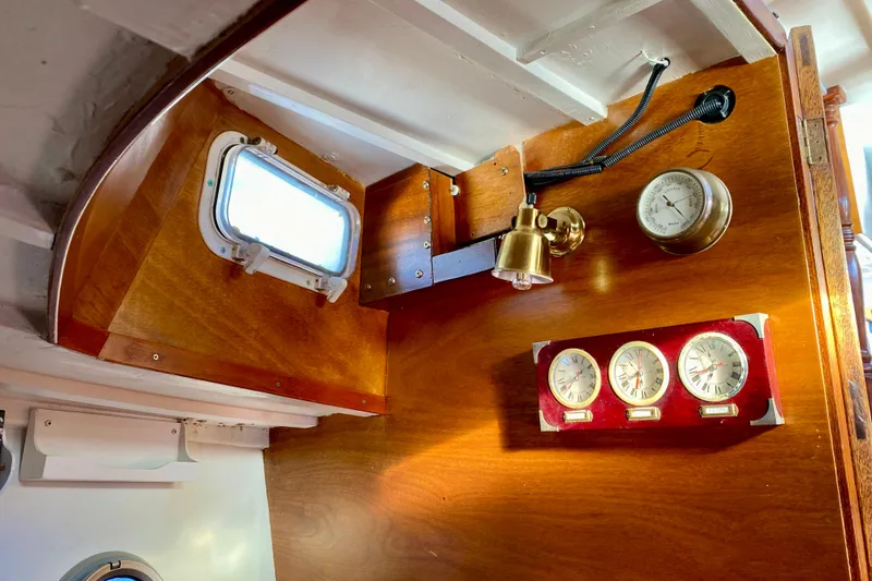 Slide: The Image of Interior of 1979 Outer Reef 26/31 boat with wooden paneling and nautical instruments. - 84