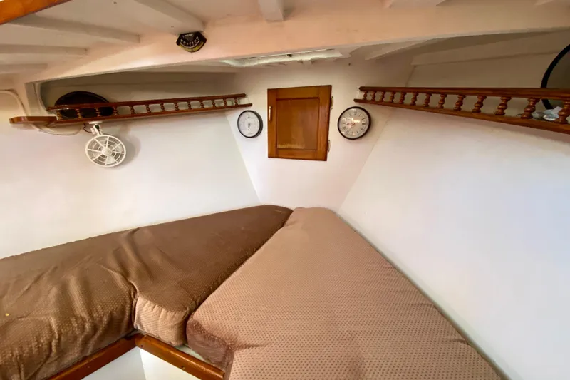 Slide: The Image of Cozy cabin interior of 1979 Outer Reef 26/31 with twin beds and wooden shelves. - 87