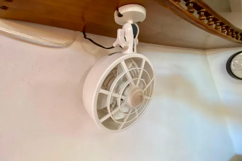 Slide: The Image of Vintage 1979 Outer Reef 26/31 wall-mounted fan in a room corner. - 90