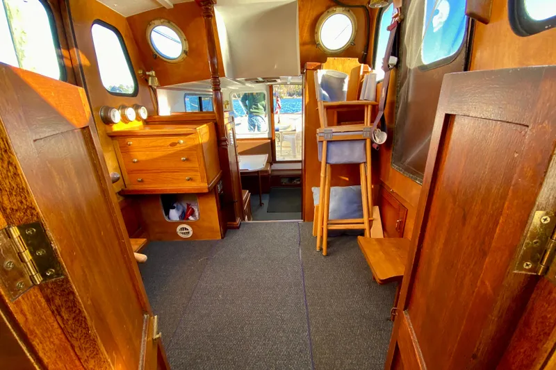 Slide: The Image of Interior of a 1979 Outer Reef 26/31 boat with wooden furnishings and nautical decor. - 92