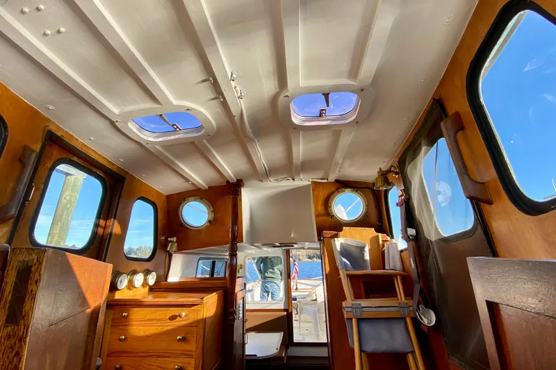 Slide: The Image of Interior of a 1979 Outer Reef 26/31 boat with wooden furnishings and porthole windows. - 93