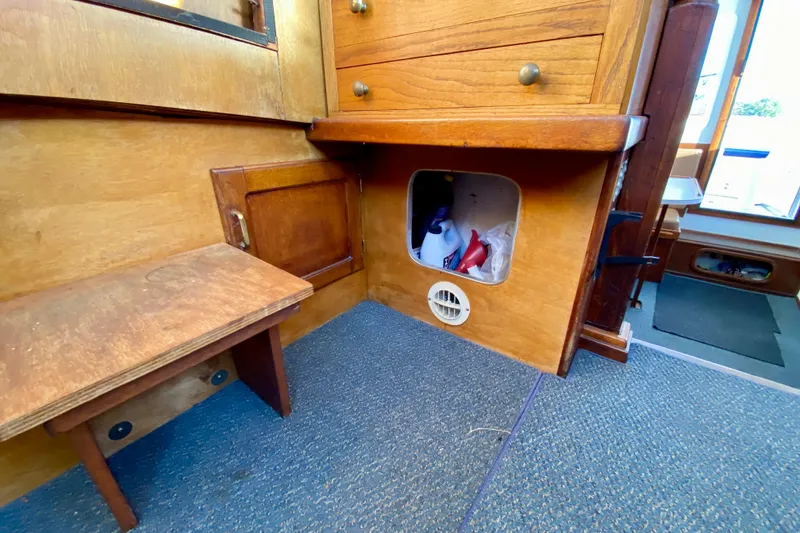 Slide: The Image of 1979 Outer Reef 26/31 interior with wooden cabinetry and storage compartment. - 94