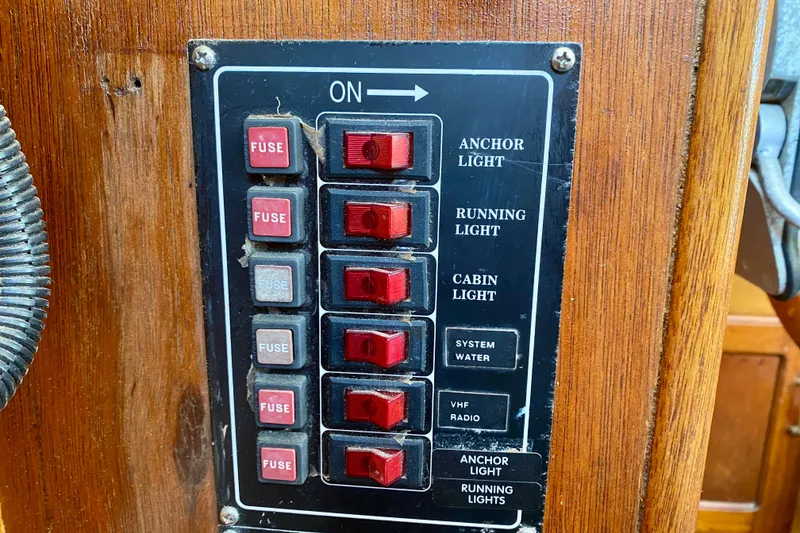 Slide: The Image of Control panel of a 1979 Outer Reef 26/31 boat with switches and fuses. - 97