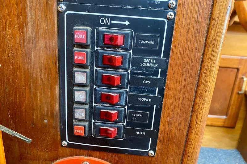 Slide: The Image of Control panel of a 1979 Outer Reef 26/31 boat with switches and fuses. - 98