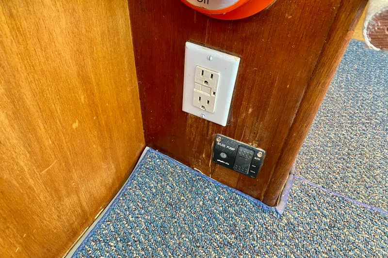 Slide: The Image of Power outlet and bilge pump switch on 1979 Outer Reef 26/31 boat interior. - 99