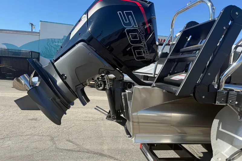 Slide: The Image of 2026 Avalon 2785 QL boat with powerful outboard motor, parked outdoors. - 4