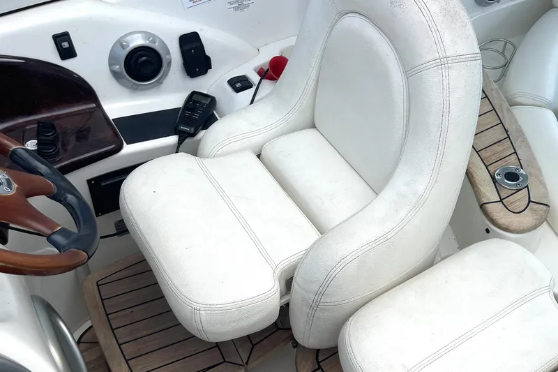 Slide: The Image of Captain's seat on 2006 Cranchi Mediterranee 50 HT yacht, featuring white upholstery and wooden accents. - 11
