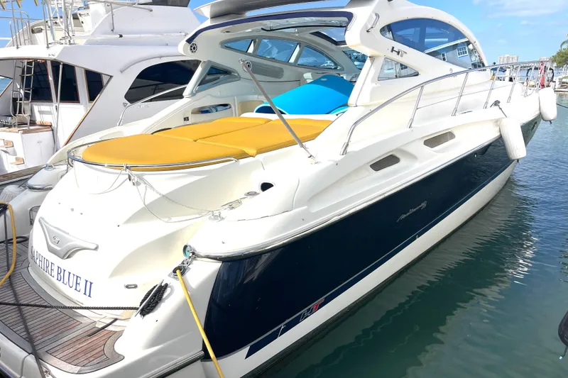 Slide: The Image of 2006 Cranchi Mediterranee 50 HT yacht docked, featuring sleek design and vibrant yellow seating. - 19