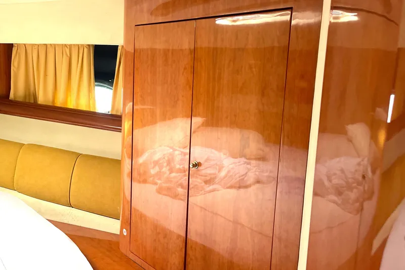 Slide: The Image of Interior of 2006 Cranchi Mediterranee 50 HT yacht with wooden cabinetry and yellow seating. - 3