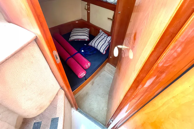 Slide: The Image of 2006 Cranchi Mediterranee 50 HT cabin interior with bed, pillows, and yoga mats. - 7