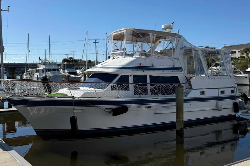 The Image of 1986 Kha Shing Spindrift yacht docked in a marina under clear blue skies. - 0