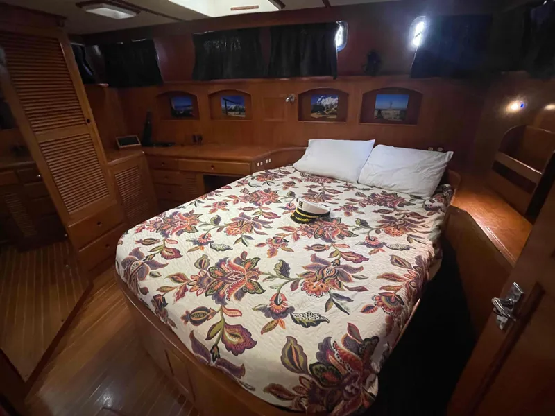 Slide: The Image of Bow view from 1986 Kha Shing Spindrift yacht approaching a bridge on a sunny day. - 11