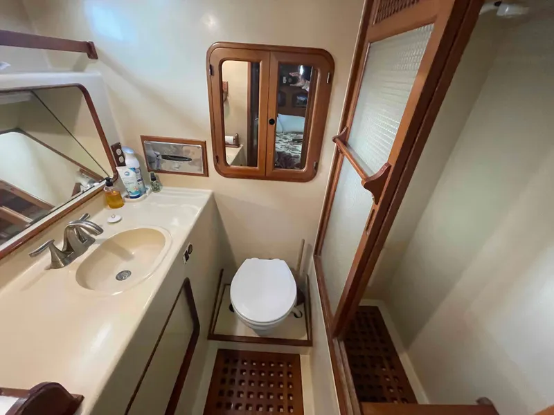 Slide: The Image of 1986 Kha Shing Spindrift yacht docked at marina under blue sky. - 12