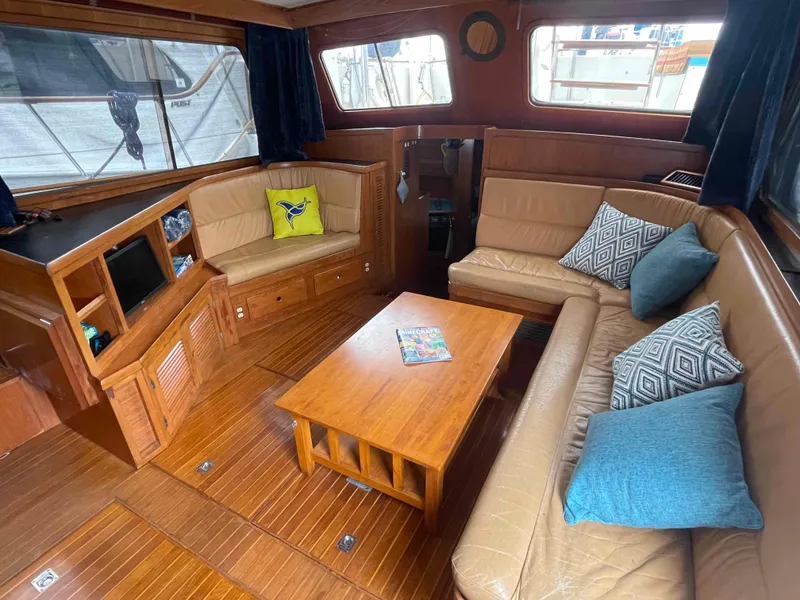 Slide: The Image of Captain's chair on 1986 Kha Shing Spindrift yacht, with ropes and cooler in background. - 16