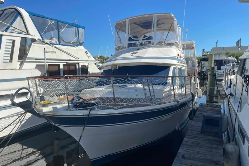 Slide: The Image of 1986 Kha Shing Spindrift yacht bedroom with anchor-themed bedding and wooden interior. - 2