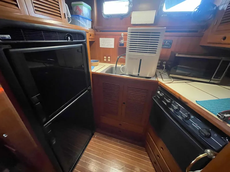 Slide: The Image of Interior of a 1986 Kha Shing Spindrift yacht with wooden floor and leather sofas. - 30