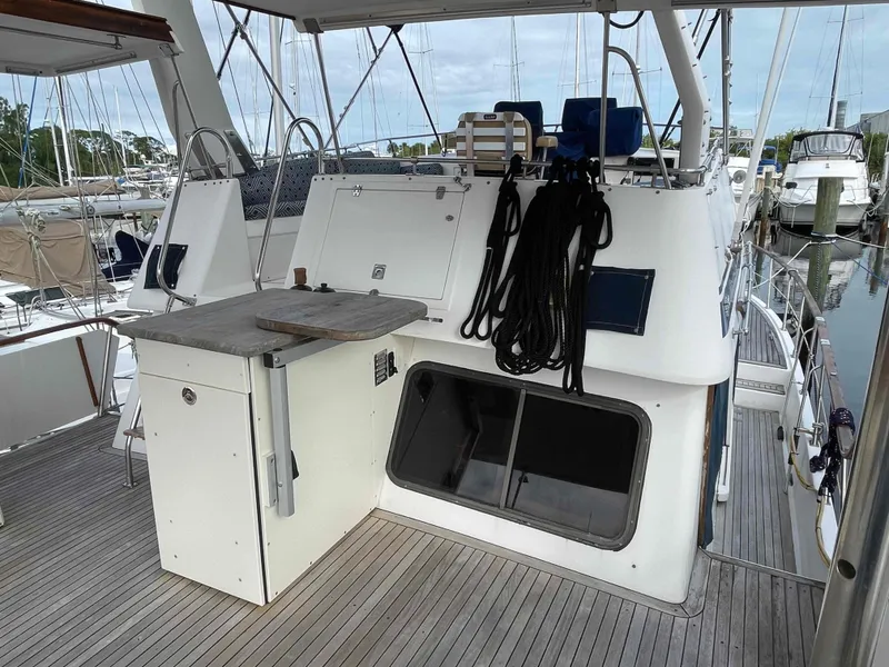 Slide: The Image of 1986 Kha Shing Spindrift deck with wooden flooring and seating area. - 35