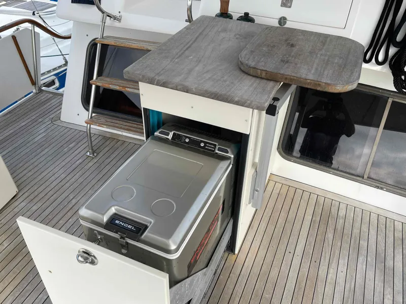 Slide: The Image of Kha Shing Spindrift 1986 yacht with wooden table on deck. - 37