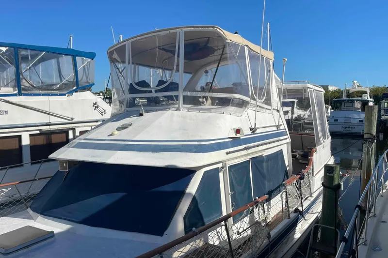 Slide: The Image of 1986 Kha Shing Spindrift yacht docked at marina under clear blue sky. - 53