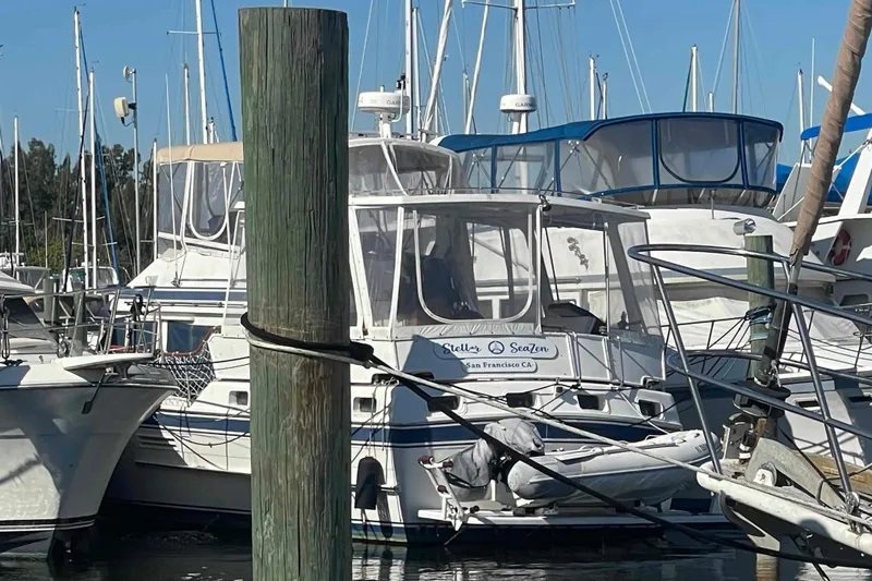Slide: The Image of 1986 Kha Shing Spindrift yacht docked in marina, surrounded by other boats. - 56