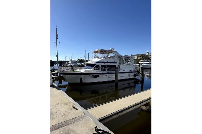 Slide: The Image of 1986 Kha Shing Spindrift yacht docked at marina under clear blue sky. - 57