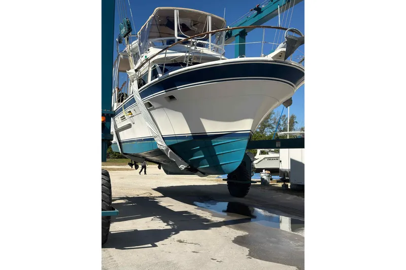 Slide: The Image of 1986 Kha Shing Spindrift yacht lifted for maintenance at a marina. - 58