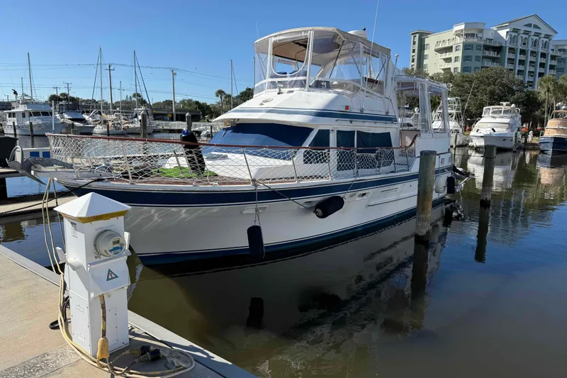 Slide: The Image of 1986 Kha Shing Spindrift yacht docked at a marina on a sunny day. - 59